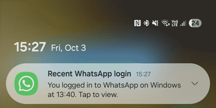 A phone lock screen showing a notification that a messaging account has been logged in to on a Windows computer.